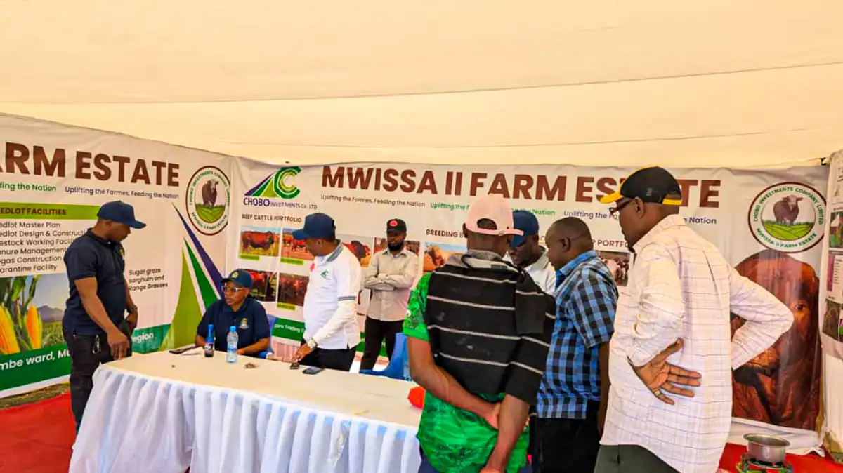 Visitors gather at a farm estate exhibition stand.