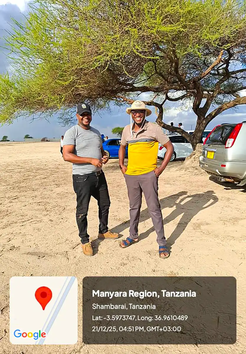 Two people stand outdoors; a precise location and timestamp overlay appears at the bottom.